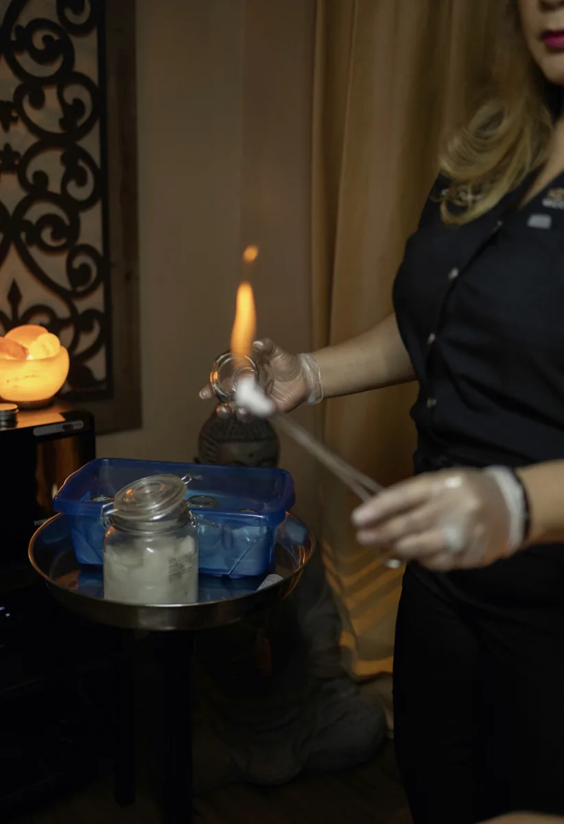 Dr. Rusnak lighting the cotton swab used to seat a fire cup